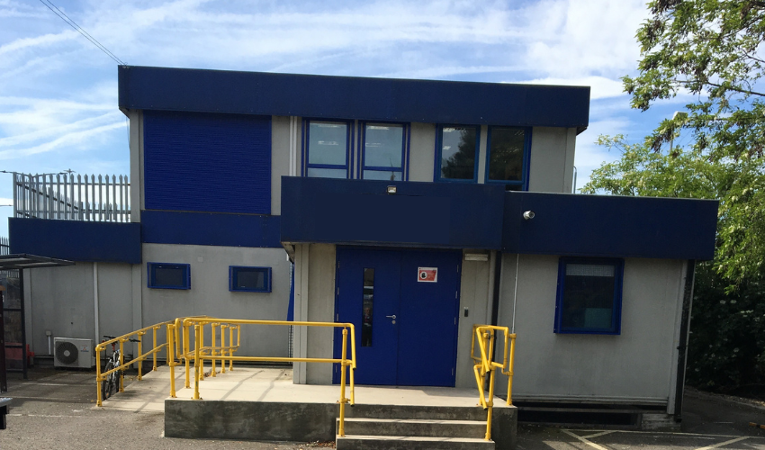 Two storey modular building exterior with blue trim and entrance ramp
