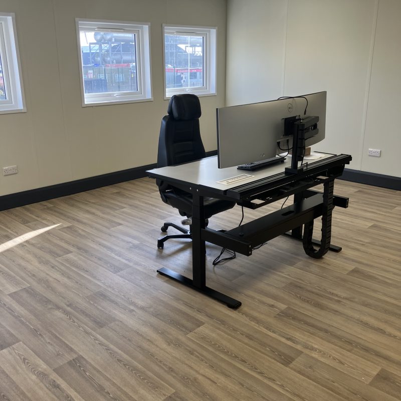 Modular office space with desk, monitors and chair