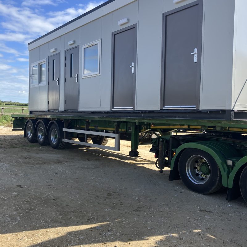 Portable building loaded on trailer ready for nationwide delivery